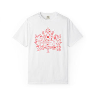 A white short-sleeve crewneck t-shirt featuring a red graphic of a maple leaf filled with illustrations of Canadian landmarks and scenery, displayed on a clean white background.