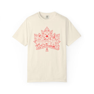 An off-white short-sleeve t-shirt with a red graphic of a Canadian maple leaf filled with city silhouettes, displayed on a clean white background.