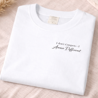I Don’t Compete I Arrive Different Embroidered Unisex Tee